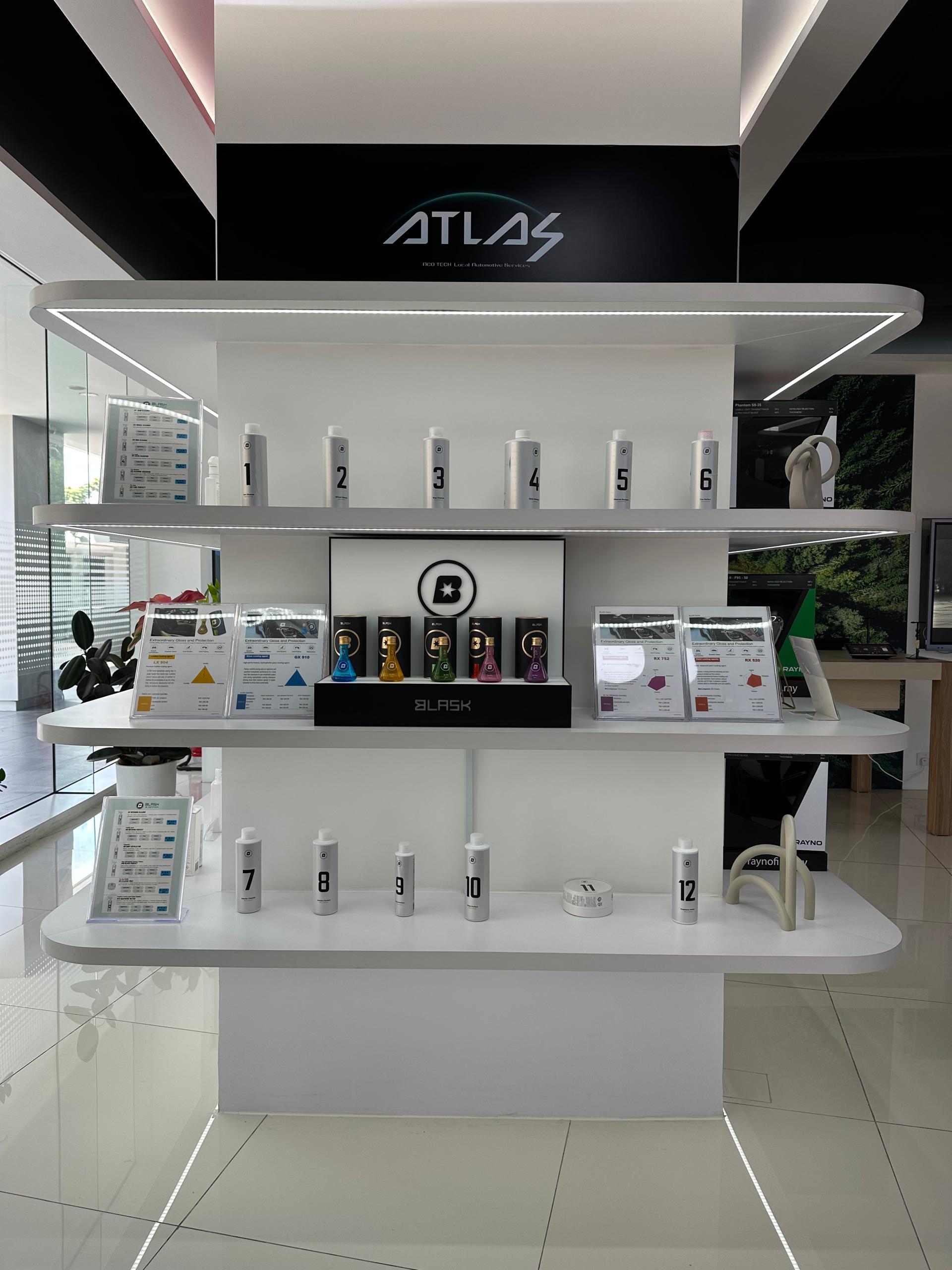 Car care products and window film specification cards on showroom shelves